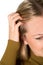 Studio Shot Of Young Woman Itching Scalp