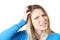 Studio Shot Of Young Woman Itching Scalp