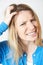 Studio Shot Of Young Woman Itching Scalp