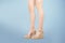 Studio shot of a young woman`s legs in a pair of pink platform wedge shoes