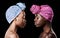 Studio, sisters and black women with skincare for beauty, profile and head wrap for aesthetic. Dark background, African