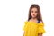Studio waist up portrait of a little serious girl wearing yellow sundress , isolated  with copy space