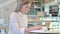 Studious young woman reading book in cafe