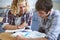 Study partners. Shot of two male students studying together in class.