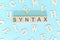 Study syntax in linguistics concept. Wooden blocks word typography flat lay in blue background.