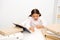 Studying hard. Girl child reads book while sit table white background. Schoolgirl studying and reading book. Kid school