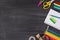 Studying at home concept. Top above overhead view photo of colorful stationery placed to the right side isolated on blackboard