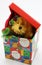 Stuffed bear toy peaking out of Christmas box