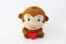 Stuffed brown monkey holding a red heart.