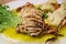 Stuffed calamari in butter sauce with vegetables - selective focus