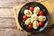 Stuffed deviled eggs with tuna and avocado served with tomatoes