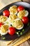 Stuffed deviled eggs with tuna and avocado served with tomatoes