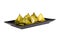 Stuffed dough pyramid on a black plate clipping path