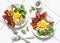 Stuffed egg crepes with bacon and arugula - delicious nutritious brunch on a light background, top view. Flat lay