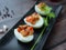 Stuffed Eggs with minced pork Tomato,Onions,Garlic,Pepper stir well,Place the filling on a boiled egg on a Black plate,Background