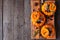 Stuffed fall mini pumpkins with rice, cranberries, cabbage and nuts above view on platter over rustic wood