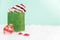 A stuffed green sparkly gift bag on green background
