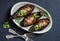 Stuffed lentils roasted eggplant - delicious healthy vegetarian lunch, snack, appetizer on a dark background