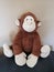 Stuffed monkey plush toy sitting patiently