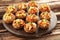 Stuffed mushrooms on cutting board on brown wooden background