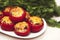 Stuffed mushrooms tomatoes with cheese baked in the oven on a background of green parsley. Vegetarian dish.