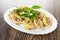 Stuffed pasta conchiglie, parsley in dish on dark wooden table