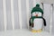 Stuffed penguin toy animal on white rocking chair close up