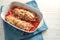 Stuffed pointed bell peppers with rice, tuna, tomatoes and cheese baked in a casserole fresh from the oven, blue napkin and white