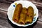 Stuffed squash, courgette, marrow, mahshi, or zucchini filled with white rice, onion, parsley, dill and coriander, selective focus