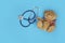 Stuffed teddy bears animal presented as a pediatrician holding a stethoscope with copy space on blue  background