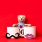 The stuffed toy teddy bear and couple cups of coffee with lips and mustache on red background, Dating on valentines day.