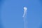 Stund plane doing a loop with smoke in turquoise blue sky