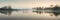 Stuning tranquil landscape panorama of lake in mist
