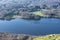 Stuning vibrant Autumn Fall landscape image of view from Gummers How down onto Derwent Wter in Lake District