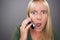 Stunned Blond Woman Using Cell Phone