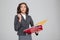 Stunned business woman holding documents in binders