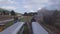 Stunning 4k aerial of steam engine train carriages and locomotive with puffs