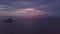 Stunning 4k sunset aerial flying over foliage, blue sea and purple cloudscape