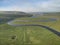 Stunning aerial drone landscape image of meandering river through marshland at sunrise