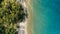 Stunning aerial drone minimal geometric image of a remote tropical sea ocean shore with sandy rocky beach lush rainforest jungle