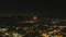 Stunning aerial footage of fireworks on the fourth of July at night with a landscape filled with city lights and mountain ranges