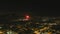 Stunning aerial footage of fireworks on the fourth of July at night with a landscape filled with city lights and mountain ranges