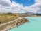 Stunning aerial high angle drone view of State Highway 8 leading along the shores of Lake Pukaki, an alpine lake
