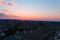 A stunning aerial shot of the blue sky with powerful red clouds at sunset