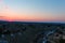 A stunning aerial shot of the blue sky with powerful red clouds at sunset