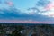 A stunning aerial shot of the blue sky with powerful red clouds at sunset