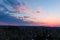 A stunning aerial shot of the blue sky with powerful red clouds at sunset