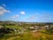 Stunning aerial shot of the cities of Carlsbad and Encinitas with views of buildings, homes, the river, streets with blue sky