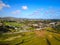 Stunning aerial shot of the cities of Carlsbad and Encinitas with views of buildings, homes, the river, streets with blue sky