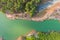 A stunning aerial shot of the lush green and autumn colored trees along the banks of the silky green Catawba River in Charlotte